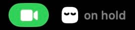 Elye in the menu bar on hold during a call, eyes closed contentedly